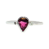 Lady's 14 Karat White Gold Ring featuring a Bezel-Set Pear-Shape Ruby and Diamond Accents